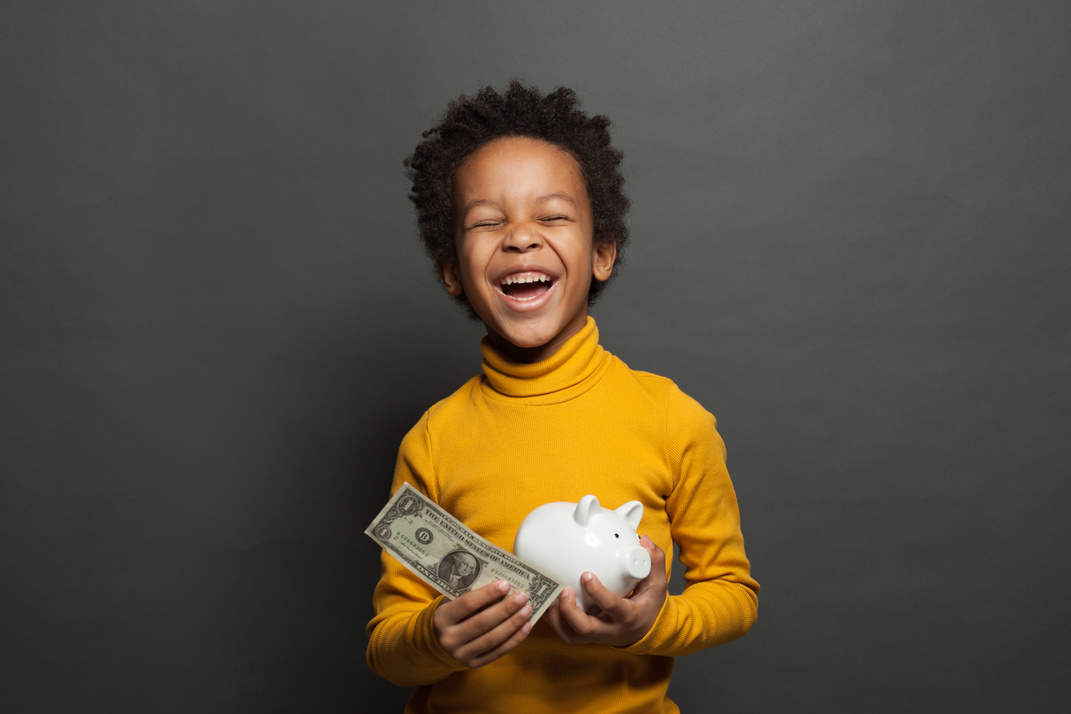 Happy black child boy with us dollar and money box